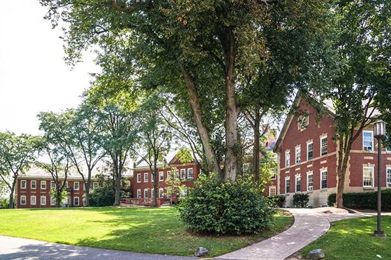 Photo of redbrick 学术 buildings framing a green quad on Chatham University's Shadyside campus. 
